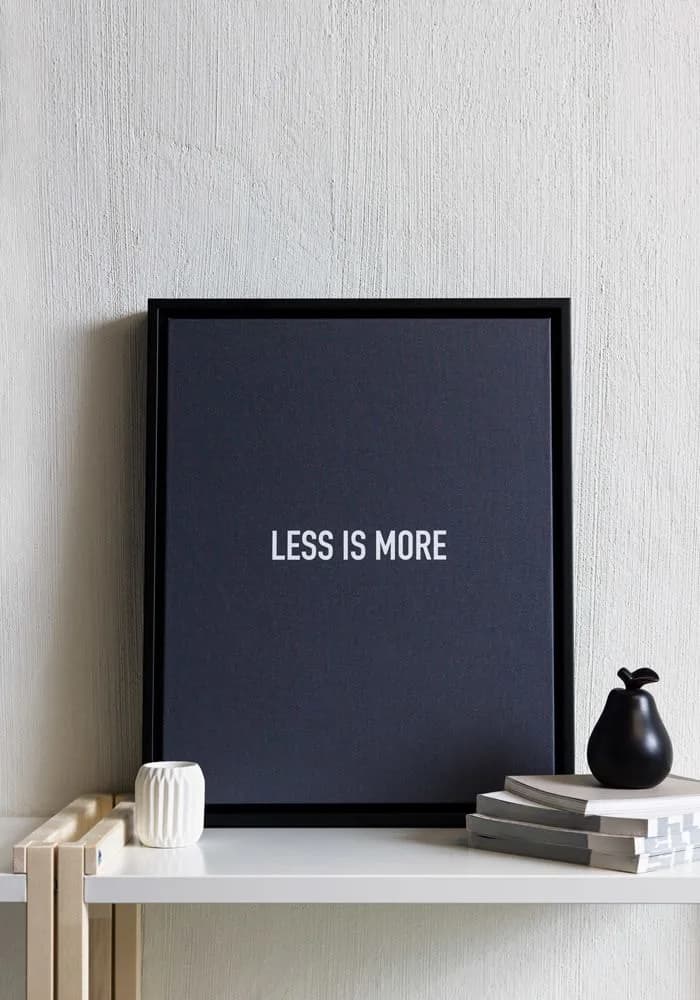 Sample black framed canvas displayed on a shelf